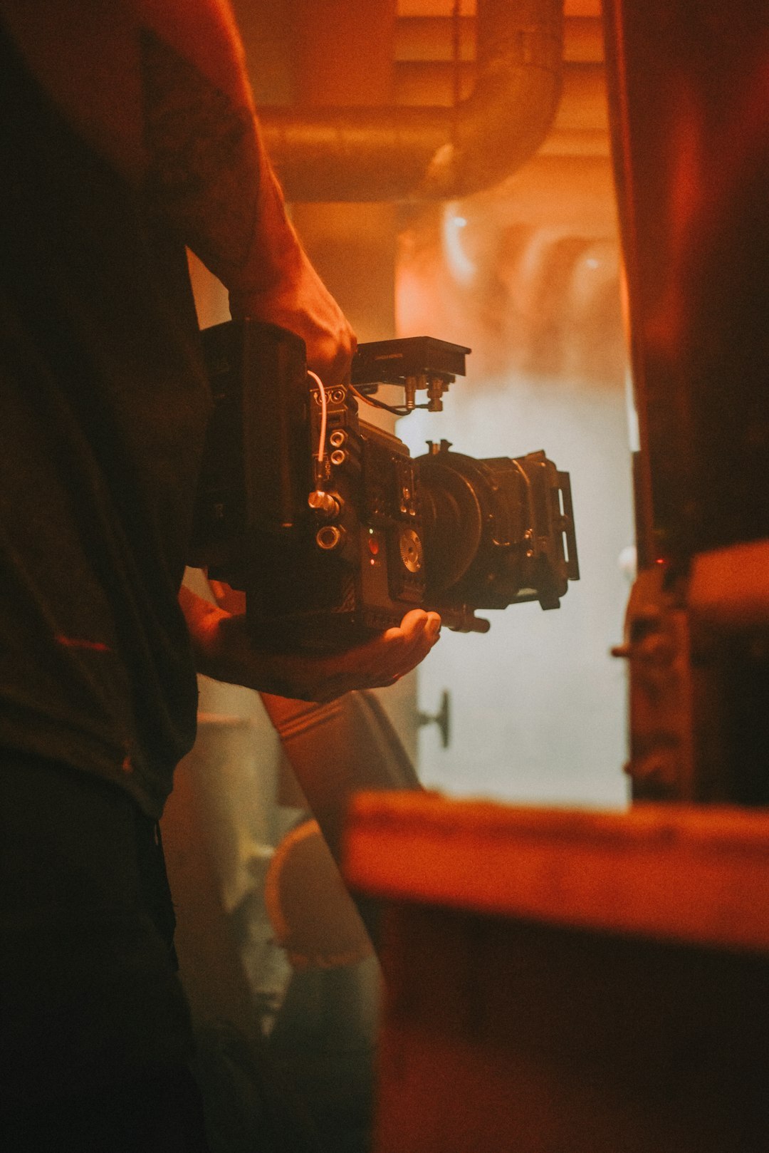 person filming with camera