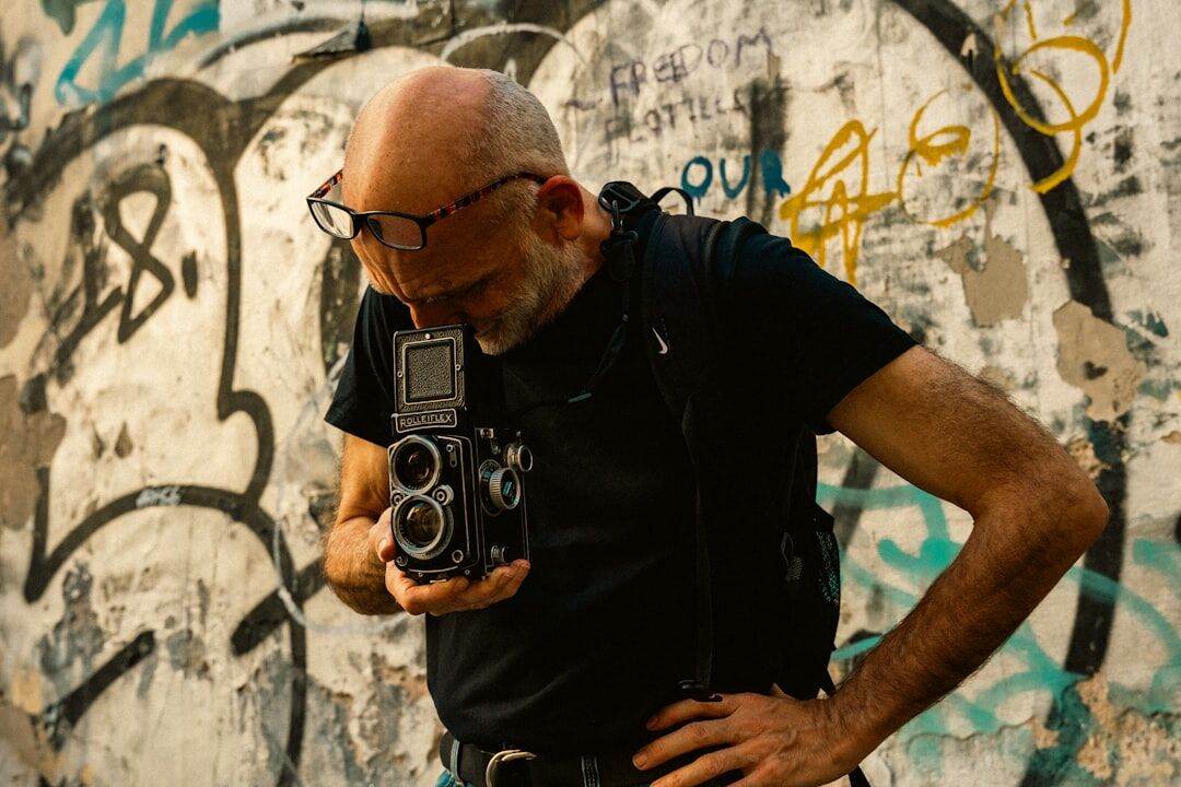 Portrait of a Czech man in his 50s, journalism expert, with a beard and glasses