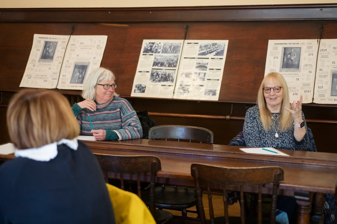 Academic panel of researchers discussing findings around a table with documents